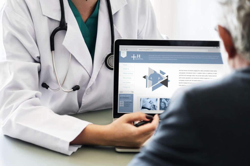 doctor with patient reviewing website